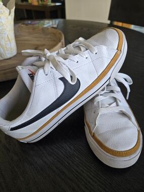 Nike White Low-Top Sneakers with Black Swoosh and Mustard Trim